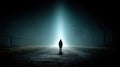 lone silhouette stands in beam of light on dark, misty road Royalty Free Stock Photo