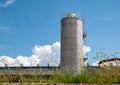 Lone silo tower on blue sky background. Storage of agriculturals or chemicals Royalty Free Stock Photo