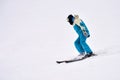 A lone skier descends a snow-covered slope. Copy space