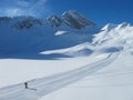 Lone skier on ski piste on sunny winter day