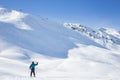 Lone skier waving on a snowy mountain peak Royalty Free Stock Photo