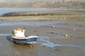 Lone small fishing boat on a sandy beach at low tide at Trefor, north Wales.