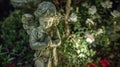 A lone statue of a cherub adorned with fragrant flower garlands stands as a symbol of the peacefulness that envelops the