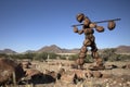 Lone stone man of Kaokoland walking to a gathering at Marble. Kunene Region, Namibia. low angle of the statue.