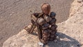 A lone stone man sitting on a rock in the desert.   These lone men are a mystery found in the northern Kaokoveld of Namibia, Royalty Free Stock Photo