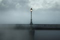 lone streetlamp on bridge with enveloping fog Royalty Free Stock Photo