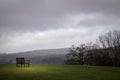 Lone summer seat in moody lake district Royalty Free Stock Photo