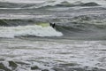 Lone Surfboard Rider in Rough Storm Waves Royalty Free Stock Photo