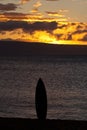 Lone surfboard sihlouetted at sunset on Maui. Royalty Free Stock Photo