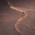 A lone surfer rides a wave during sunset in the Pacific Ocean in Palos Verdes, Southern California Royalty Free Stock Photo