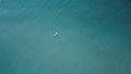 Lone surfer riding out waiting to catch waves crashing against the beach, summer vibes, coastal Victoria, Great Ocean Royalty Free Stock Photo