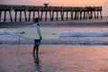 Lone surfer standing in the surf on a gorgeous morning,Jacksonville Beach,Florida,2015 Royalty Free Stock Photo