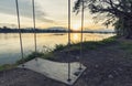 Lone swing at river side and sunset ,Thailand . Vintage Tone. Royalty Free Stock Photo