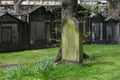 Lone tombstone surrounded by green grass in a cemetery Royalty Free Stock Photo