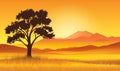 Lone tree in golden savanna at sunset with mountains Royalty Free Stock Photo