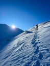 Lone trekker against the crisp blue of a winter's dawn