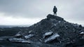 A lone wanderer stands atop a mound of debris surveying the desolate landscape with a sense of weariness and purpose. .