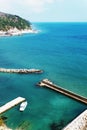 A lone white boat moored at the sea on a Sunny day. Pier with access to the blue sea Royalty Free Stock Photo