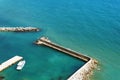 A lone white boat moored at the sea on a Sunny day. Pier with access to the blue sea Royalty Free Stock Photo