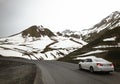 lone white car in mountain road Royalty Free Stock Photo