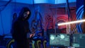 Lone wolf hacker in hideout trying to avoid being detected, using tablet