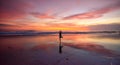 A lone woman doing yoga on a beach at sunset Royalty Free Stock Photo