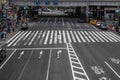 A lone woman runs across a busy intersection in Tokyo, Japan