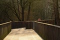 Lone women on a walkway in a sunny winter marsh