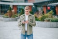 A lone young man browsing through his favorite online store on his mobile phone