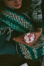 Loneliness christmas - girl sitting alone holding cup with marshmallow in a hands. Royalty Free Stock Photo