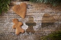 Loneliness during Christmas, a lonely gingerbread with the contour of another lying on wooden boards