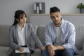 Loneliness, despair and depression concept. Professional psychologist comforting unhappy man, sitting in office