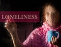 Loneliness written on virtual screen. young woman melancholy and sad at the window in the rain, she holding a cup of hot Royalty Free Stock Photo
