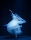 Loneliness. Young graceful beautiful woman, balerina in white wedding dress in art performance. Royalty Free Stock Photo