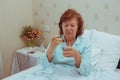 Lonelly senior woman drinking medecine.