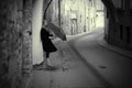 Lonelly woman with umbrella in a street, retro