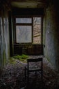 A lonely abandoned chair left opposite the window in the ghost town of Pripyat, Chernobyl in Ukraine Royalty Free Stock Photo