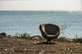 Lonely abandoned chair on the seashore