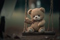 Lonely abandoned old teddy bear on swing with rusty chains