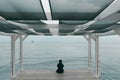 Lonely adult woman looks at the sea in autumn Royalty Free Stock Photo