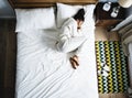 Lonely African American woman on bed sleeping alone Royalty Free Stock Photo