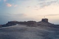 Lonely ancient stone tower on the deserted territory of Massada Fort in Israel. Early morning in Massada. Ruins of the old