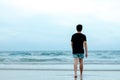 A lonely Asian man walking alone on beach Royalty Free Stock Photo