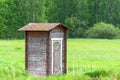 Lonely barn in green field and forest