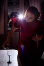 Lonely beautiful middle aged woman alone in the dark kitchen drinking red wine in the evening Royalty Free Stock Photo