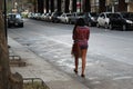 Lonely beautiful woman walking on the street