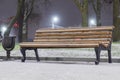 Lonely bench covered with snow at night Royalty Free Stock Photo