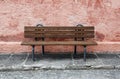 Lonely bench in front of a pastle wall