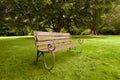 Lonely wooden bench on a green lawn Royalty Free Stock Photo