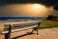 A lonely bench by the sea at sunset on the island Crete Royalty Free Stock Photo